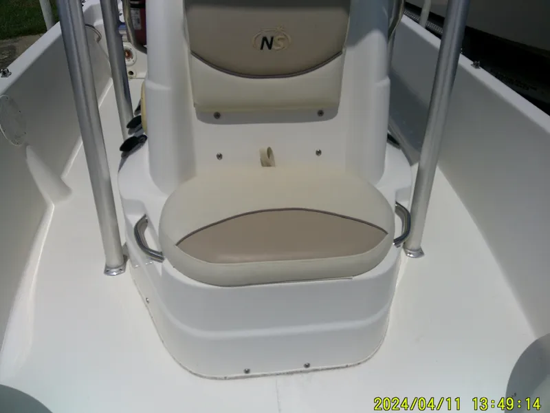 Slide: The Image of 2017 NauticStar 2140 Sport boat interior with beige seating and stainless steel railings. - 14