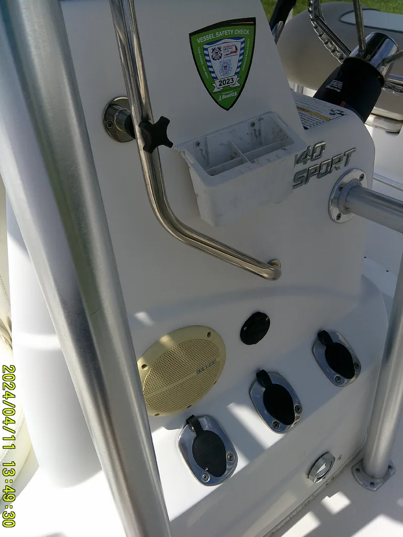 Slide: The Image of 2017 NauticStar 2140 Sport boat console with safety check sticker and controls. - 17