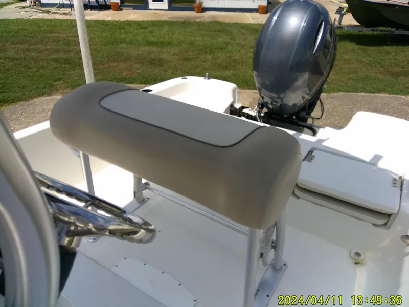 Slide: The Image of 2017 NauticStar 2140 Sport boat interior with steering wheel and outboard motor. - 18
