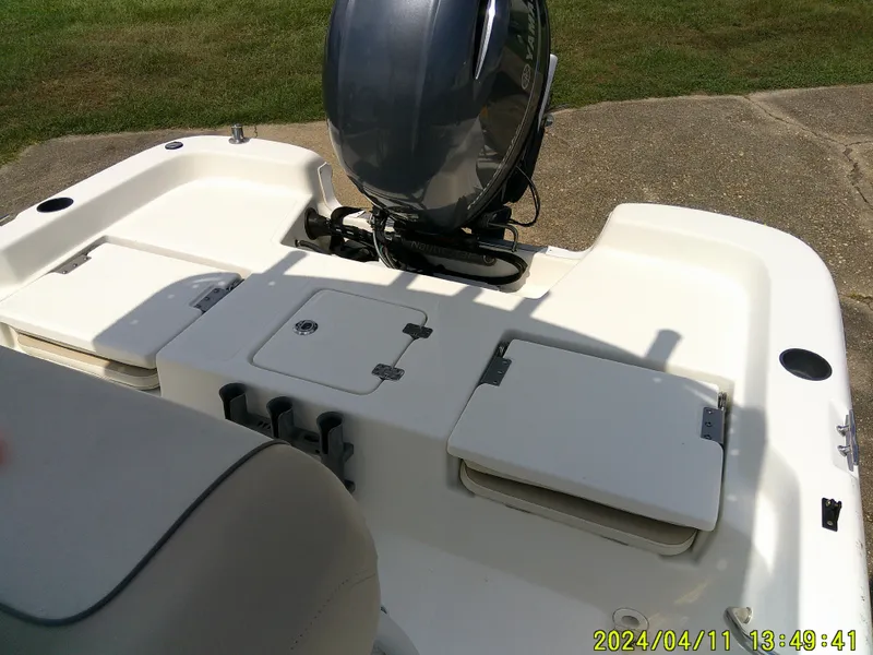 Slide: The Image of 2017 NauticStar 2140 Sport boat with outboard motor, viewed from the rear deck. - 19