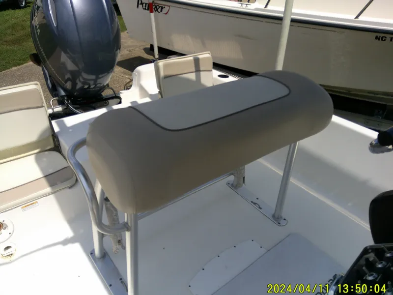 Slide: The Image of 2017 NauticStar 2140 Sport boat interior with seating and motor. - 21