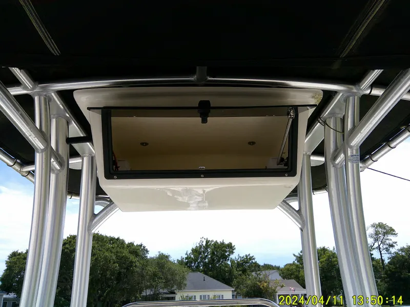 Slide: The Image of 2017 NauticStar 2140 Sport boat T-top with open storage compartment. - 23