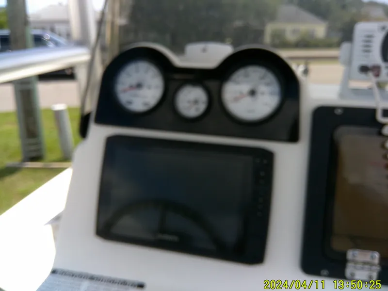 Slide: The Image of Dashboard of a 2017 NauticStar 2140 Sport boat with gauges and display. - 25