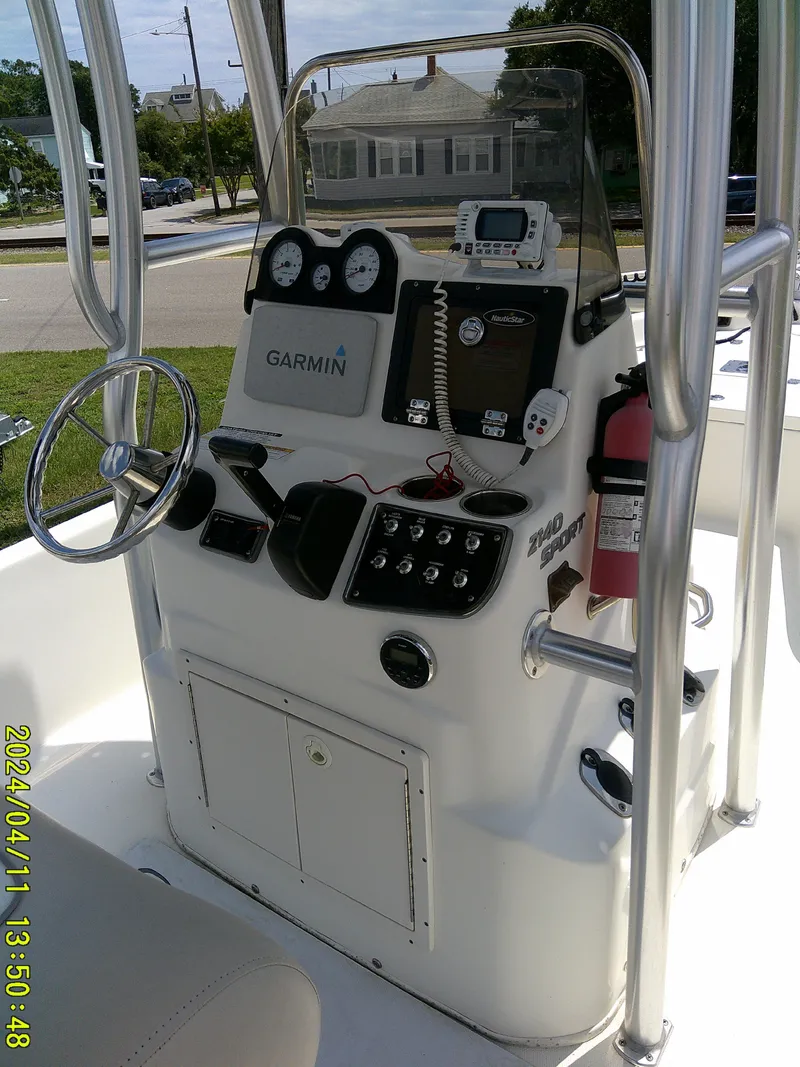 Slide: The Image of 2017 NauticStar 2140 Sport boat console with Garmin navigation and controls. - 26