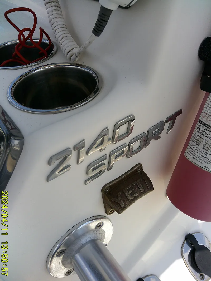 Slide: The Image of NauticStar 2140 Sport boat interior, featuring cup holders and a Yeti accessory. - 27