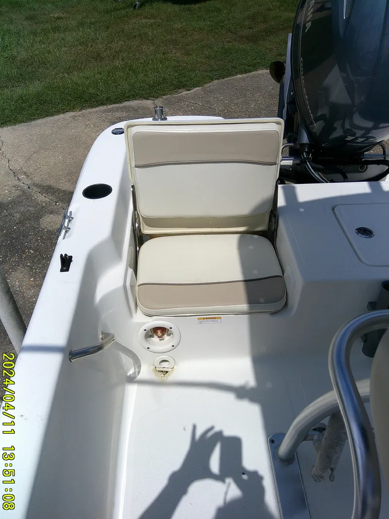 Slide: The Image of 2017 NauticStar 2140 Sport boat seat and deck, featuring white and beige upholstery. - 29