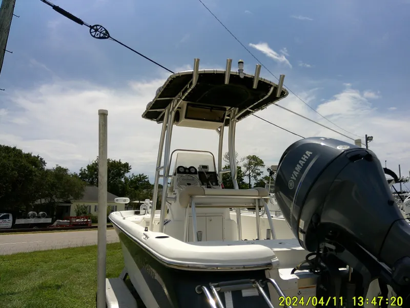 Slide: The Image of 2017 NauticStar 2140 Sport boat with Yamaha engine, parked outdoors under a clear sky. - 5