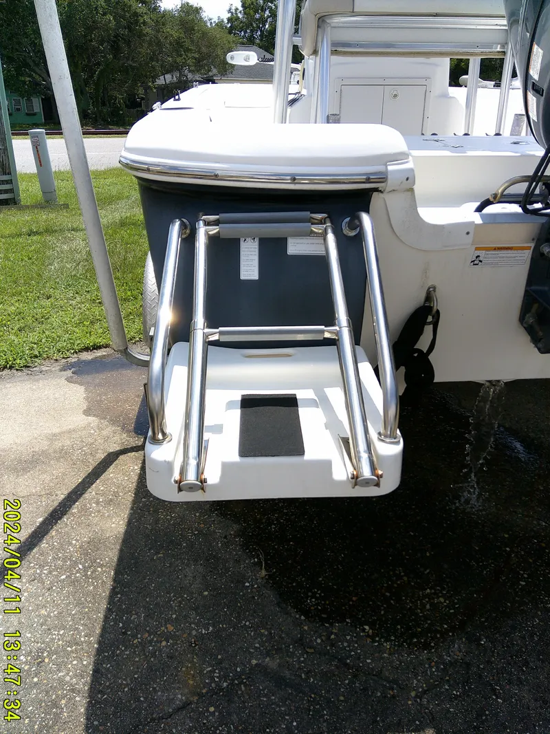 Slide: The Image of 2017 NauticStar 2140 Sport boat with rear swim ladder on a sunny day. - 6
