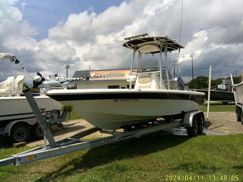 Slide: The Image of 2017 NauticStar 2140 Sport boat on trailer under cloudy sky. - 7