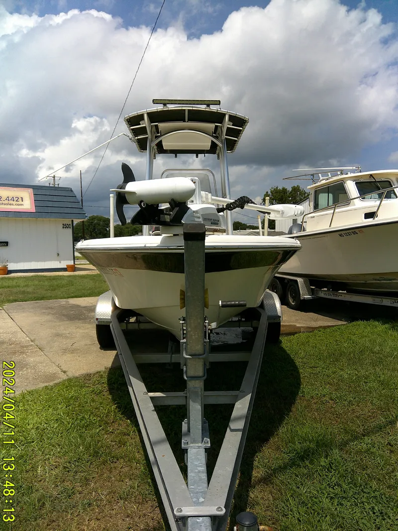 Slide: The Image of 2017 NauticStar 2140 Sport boat on trailer under cloudy sky. - 8