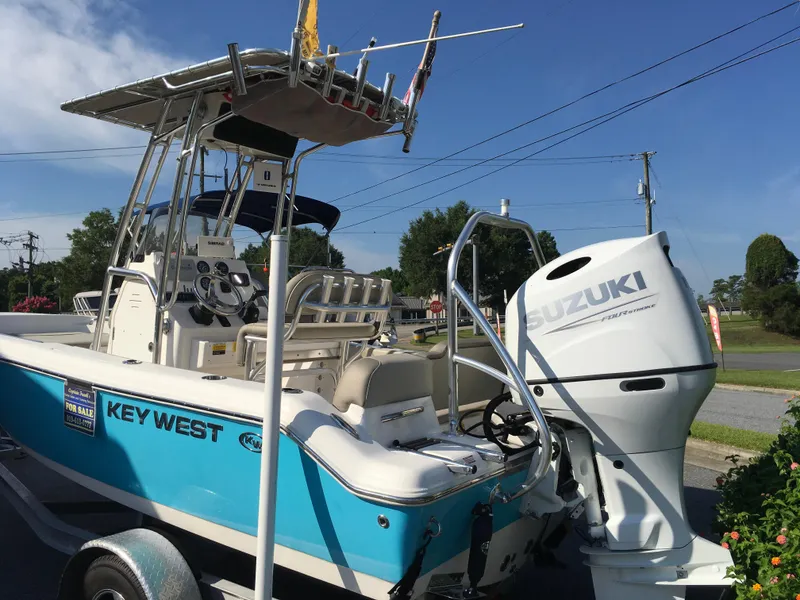 Slide: The Image of 2023 Key West 189 FS boat with Suzuki engine, parked on a trailer. - 13