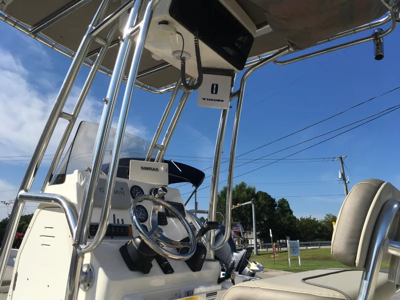 Slide: The Image of 2023 Key West 189 FS boat console with steering wheel and navigation equipment. - 14