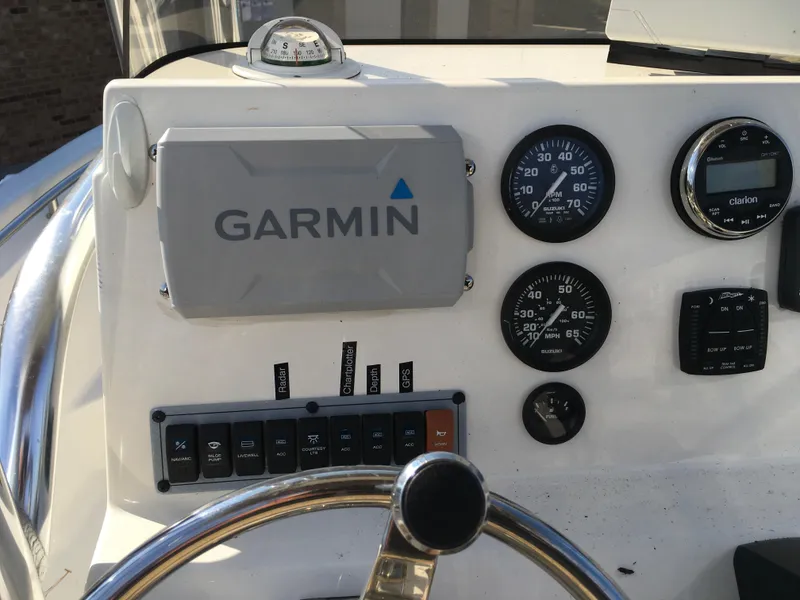Slide: The Image of 2023 Key West 189 FS boat dashboard with Garmin navigation and control gauges. - 19