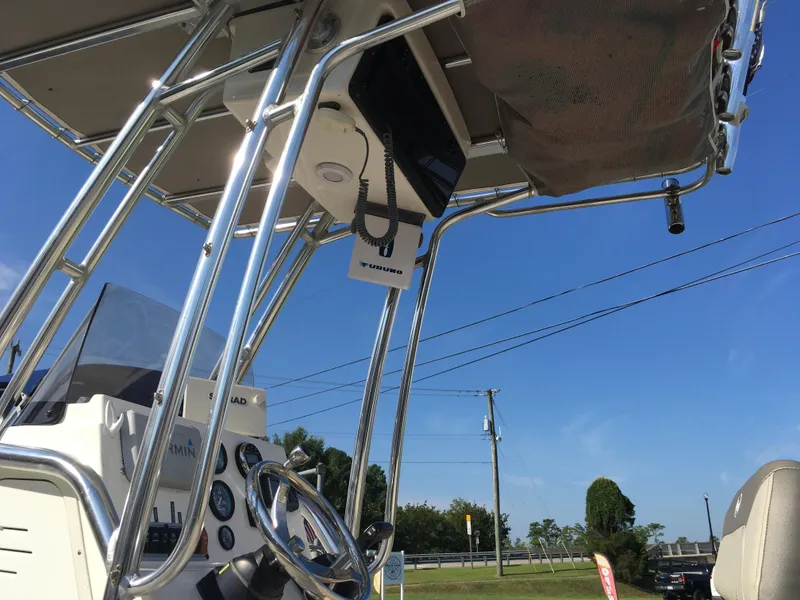 Slide: The Image of 2023 Key West 189 FS boat console with steering wheel and electronics under clear blue sky. - 21