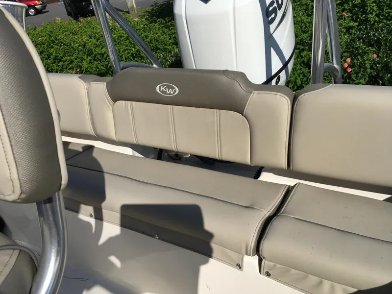 Slide: The Image of 2023 Key West 189 FS boat interior seating with KW logo and Suzuki engine. - 24