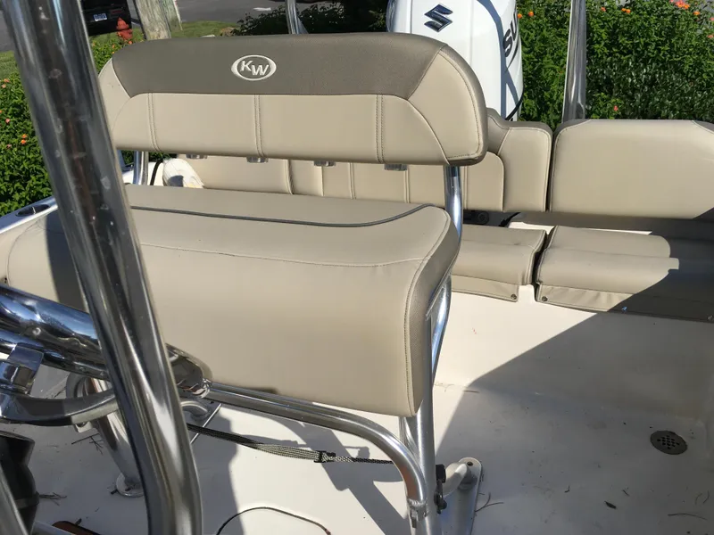 Slide: The Image of 2023 Key West 189 FS boat interior with beige seating and stainless steel details. - 25