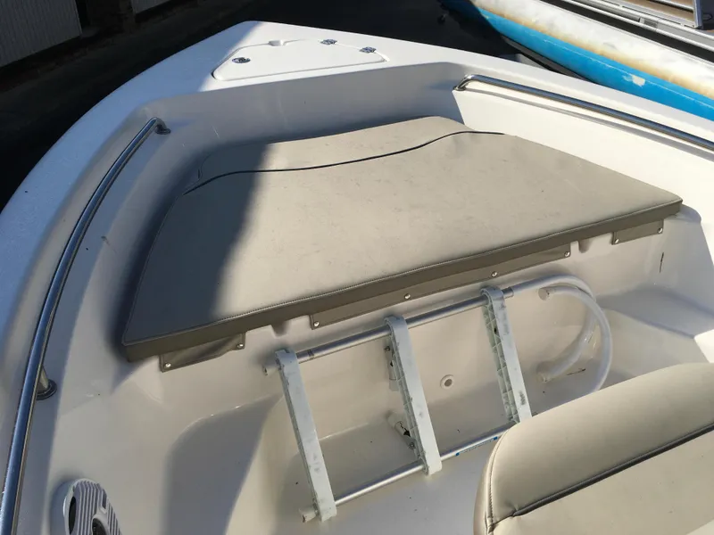 Slide: The Image of 2023 Key West 189 FS boat interior with cushioned seating and ladder. - 27