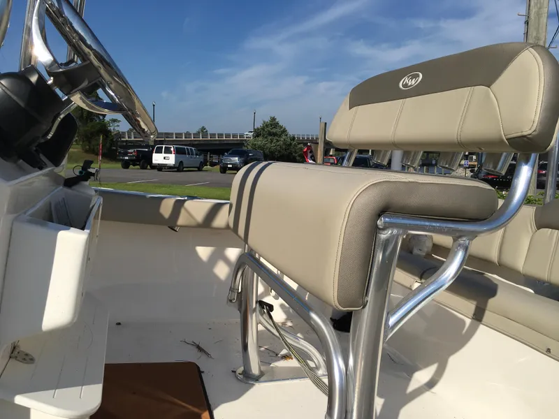 Slide: The Image of 2023 Key West 189 FS boat interior with beige seating and steering wheel. - 28