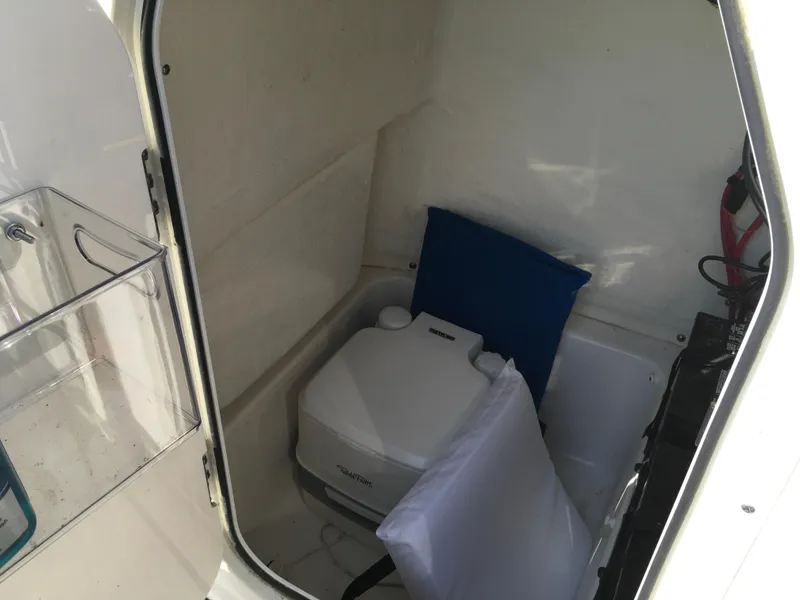 Slide: The Image of 2023 Key West 189 FS boat interior with portable toilet and storage area. - 31