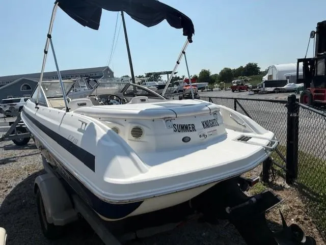 Slide: The Image of 2011 Larson LX 850 boat on trailer, outdoor setting, sunny day. - 4