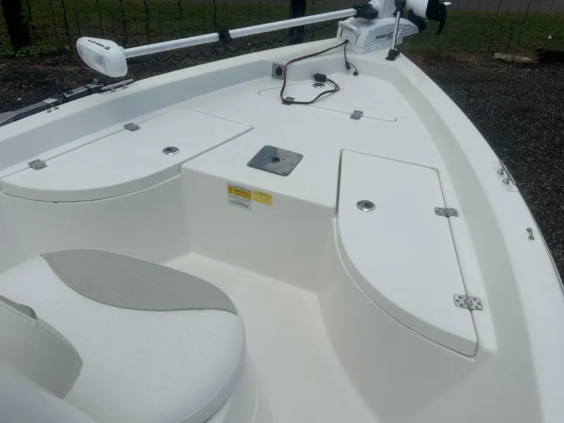 Slide: The Image of 2015 NauticStar 1810 NauticBay boat interior with storage compartments and Minn Kota trolling motor. - 23