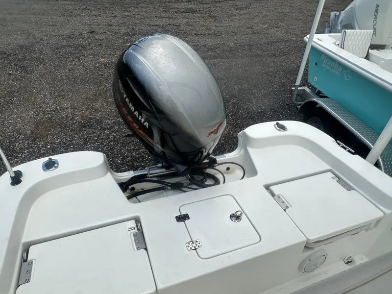 Slide: The Image of 2015 NauticStar 1810 NauticBay boat with Yamaha outboard motor on a gravel surface. - 24