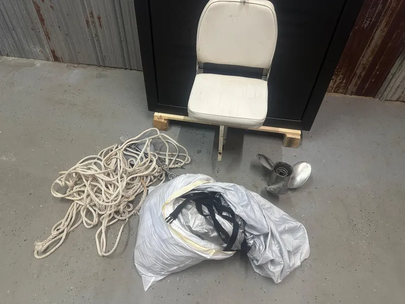Slide: The Image of Boat accessories including a chair, rope, and propeller for 2015 NauticStar 1810 NauticBay. - 30