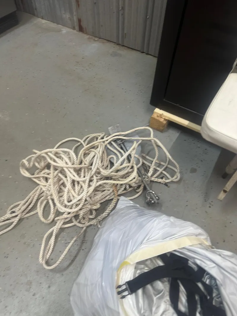 Slide: The Image of Coiled rope and bag on floor near NauticStar 1810 NauticBay boat equipment. - 33