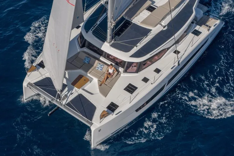 Slide: The Image of 2026 Fountaine Pajot 44 catamaran sailing on blue ocean waters. - 2