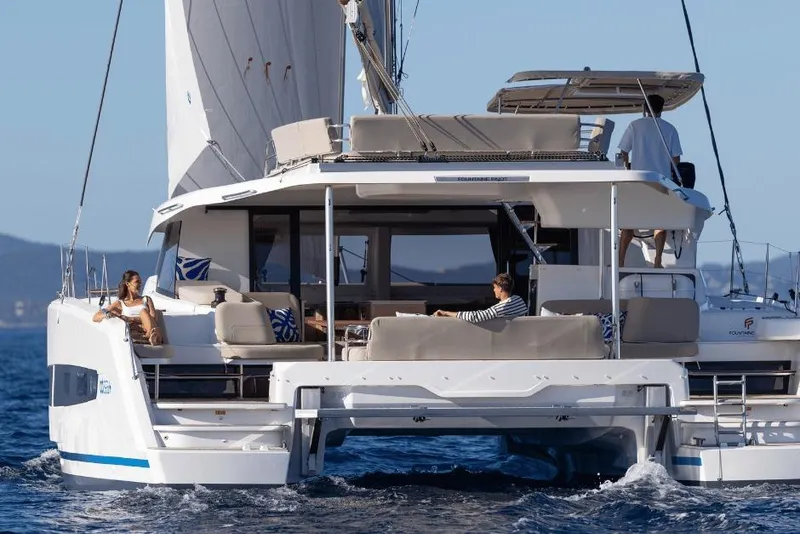 The Image of 2026 Fountaine Pajot 44 catamaran sailing with passengers, featuring spacious deck and modern design. - 0