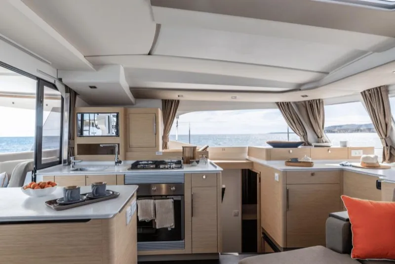 Slide: The Image of Luxurious interior of 2026 Fountaine Pajot 44 catamaran with modern kitchen and ocean view. - 14