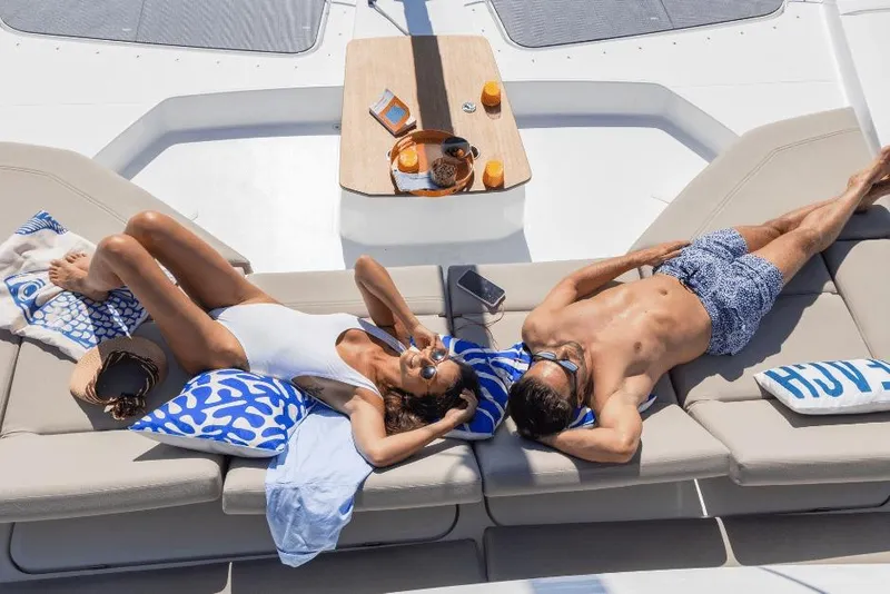 Slide: The Image of Couple relaxing on Fountaine Pajot 44 yacht, 2026 model, enjoying sunbathing with drinks. - 6