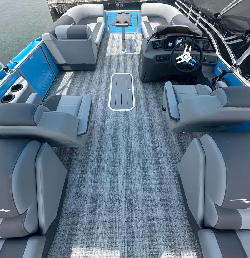 Slide: The Image of 2025 Bennington 22 SSR pontoon boat interior with gray seating and modern dashboard. - 7