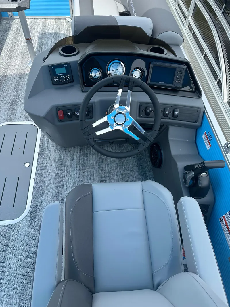 Slide: The Image of 2025 Bennington 22 SSR boat dashboard with steering wheel and control panel. - 8