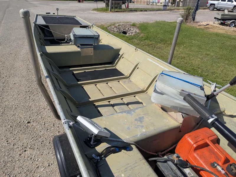 Slide: The Image of 1983 Lowe 16 Lake Jon boat with equipment, parked on a gravel surface. - 11