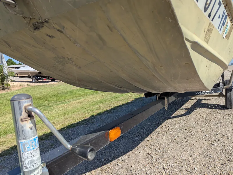 Slide: The Image of 1983 Lowe 16 Lake Jon boat on trailer, showing underside and hitch. - 12