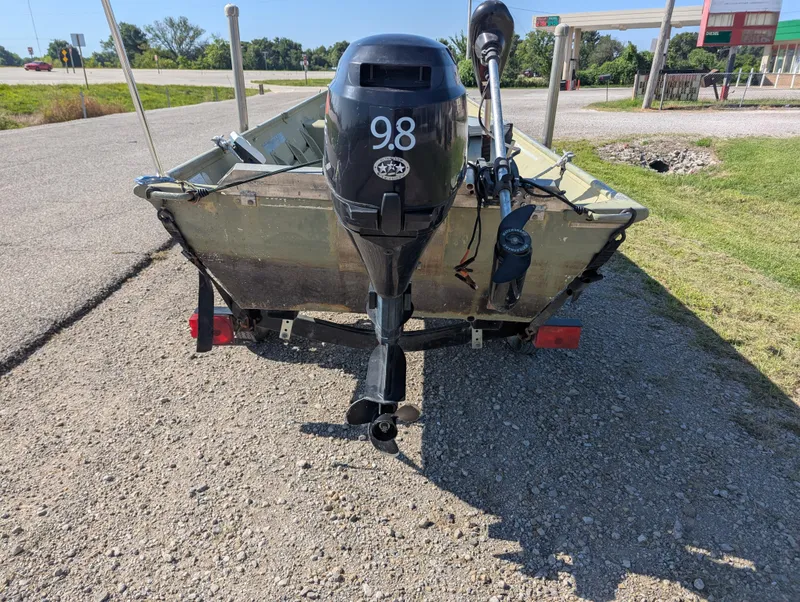 Slide: The Image of 1983 Lowe 16 Lake Jon boat with 9.8 HP motor on a trailer. - 4