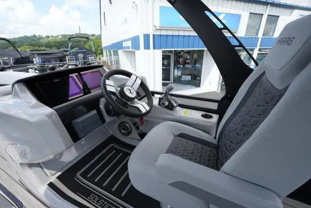 Slide: The Image of 2026 Harris Solstice 250 boat interior with modern steering and luxurious seating. - 11