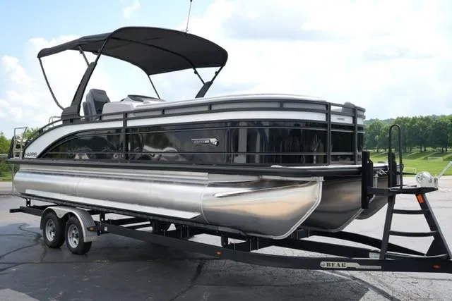Slide: The Image of 2026 Harris Solstice 250 pontoon boat on trailer, featuring sleek design and canopy. - 3