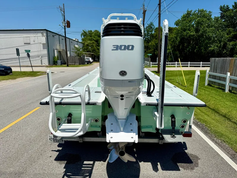 Slide: The Image of 2023 Shallow Sport 24 Sport boat with powerful 300 HP engine on a sunny street. - 3