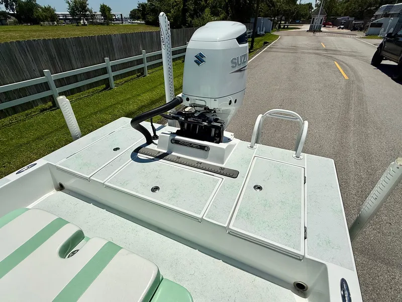 Slide: The Image of 2023 Shallow Sport 24 Sport boat with Suzuki outboard motor on a sunny day. - 7