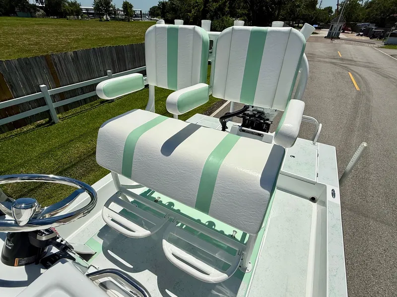 Slide: The Image of 2023 Shallow Sport 24 Sport boat with dual white and mint green seats. - 9