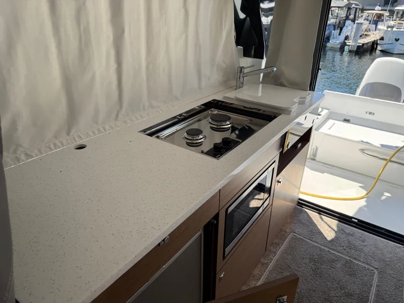 Slide: The Image of Modern kitchen area on 2022 Jeanneau NC 1095 Coupe yacht with stove and sink. - 10