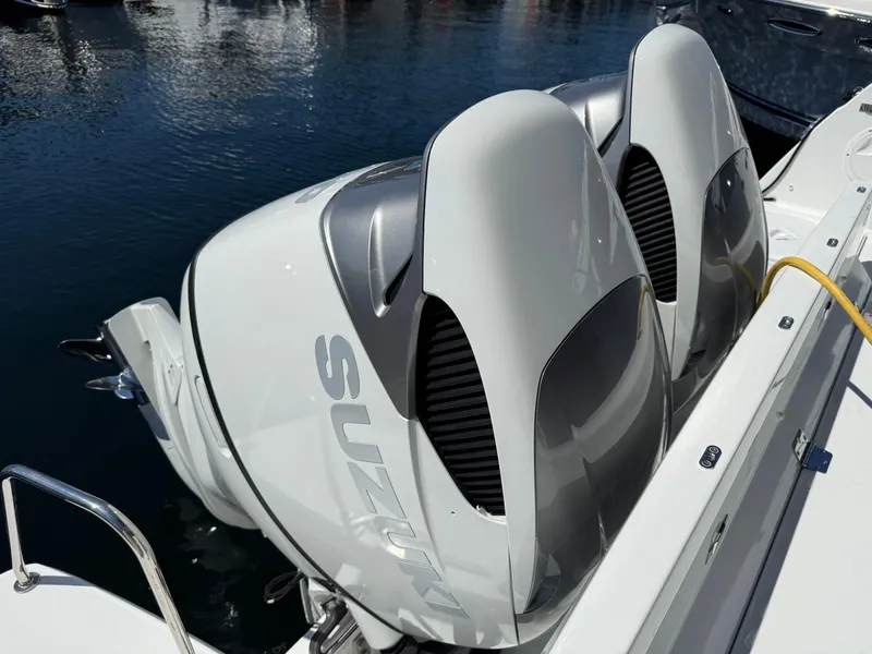 Slide: The Image of Twin Suzuki outboard engines on a 2022 Jeanneau NC 1095 Coupe boat. - 11