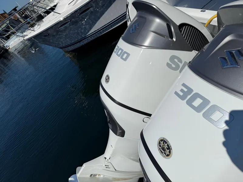 Slide: The Image of Twin Suzuki 300 outboard engines on a 2022 Jeanneau NC 1095 Coupe boat. - 12