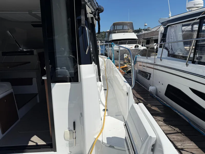 Slide: The Image of 2022 Jeanneau NC 1095 Coupe docked, showcasing sleek design and modern features. - 14