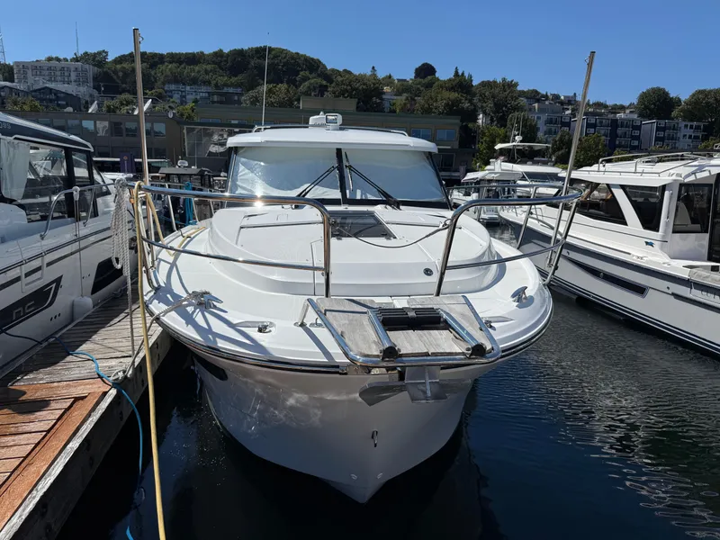 Slide: The Image of 2022 Jeanneau NC 1095 Coupe docked at marina, front view. - 17