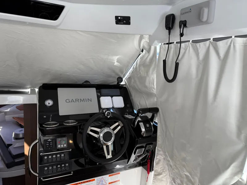Slide: The Image of 2022 Jeanneau NC 1095 Coupe helm with Garmin navigation system and controls. - 2