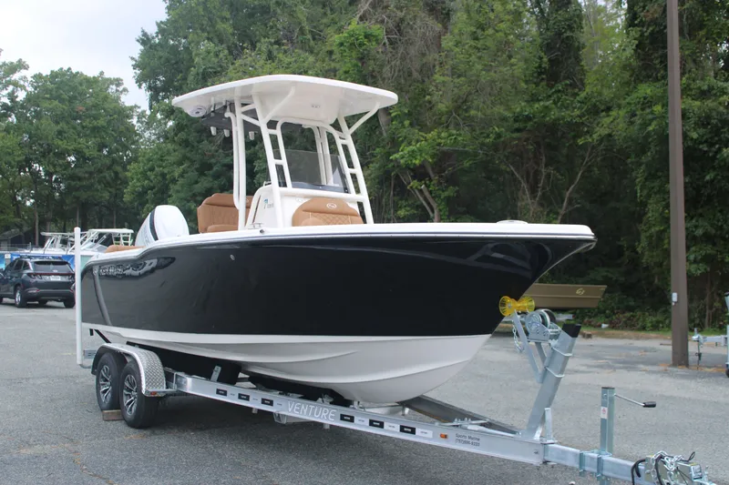 The Image of 2026 Key West 239 FS boat on trailer, parked outdoors with trees in background. - 0