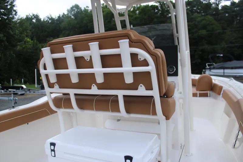 Slide: The Image of 2026 Key West 239 FS boat interior with tan seating and rod holders. - 11